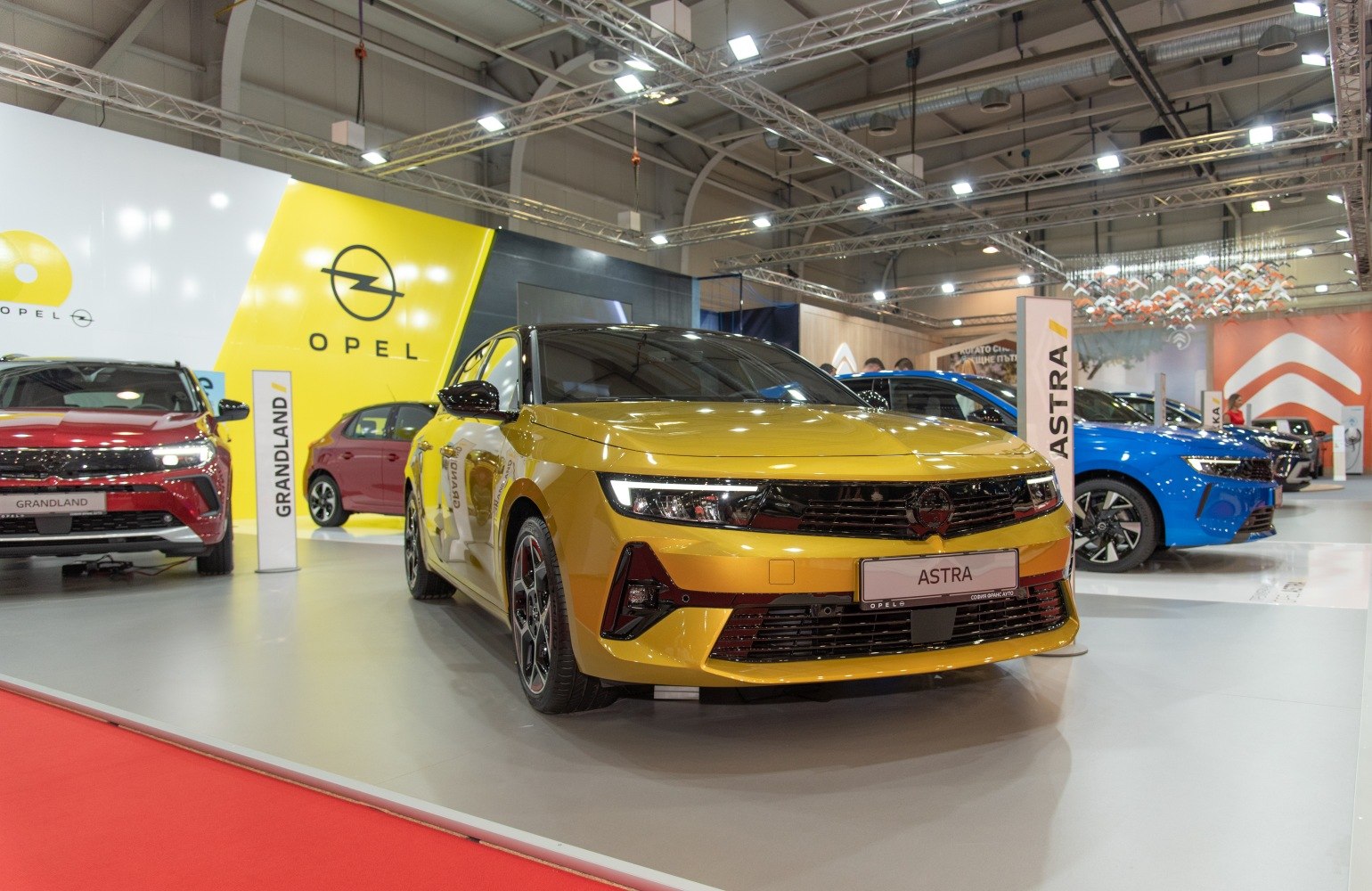 Yellow car front view with sleek headlights and sporty grille