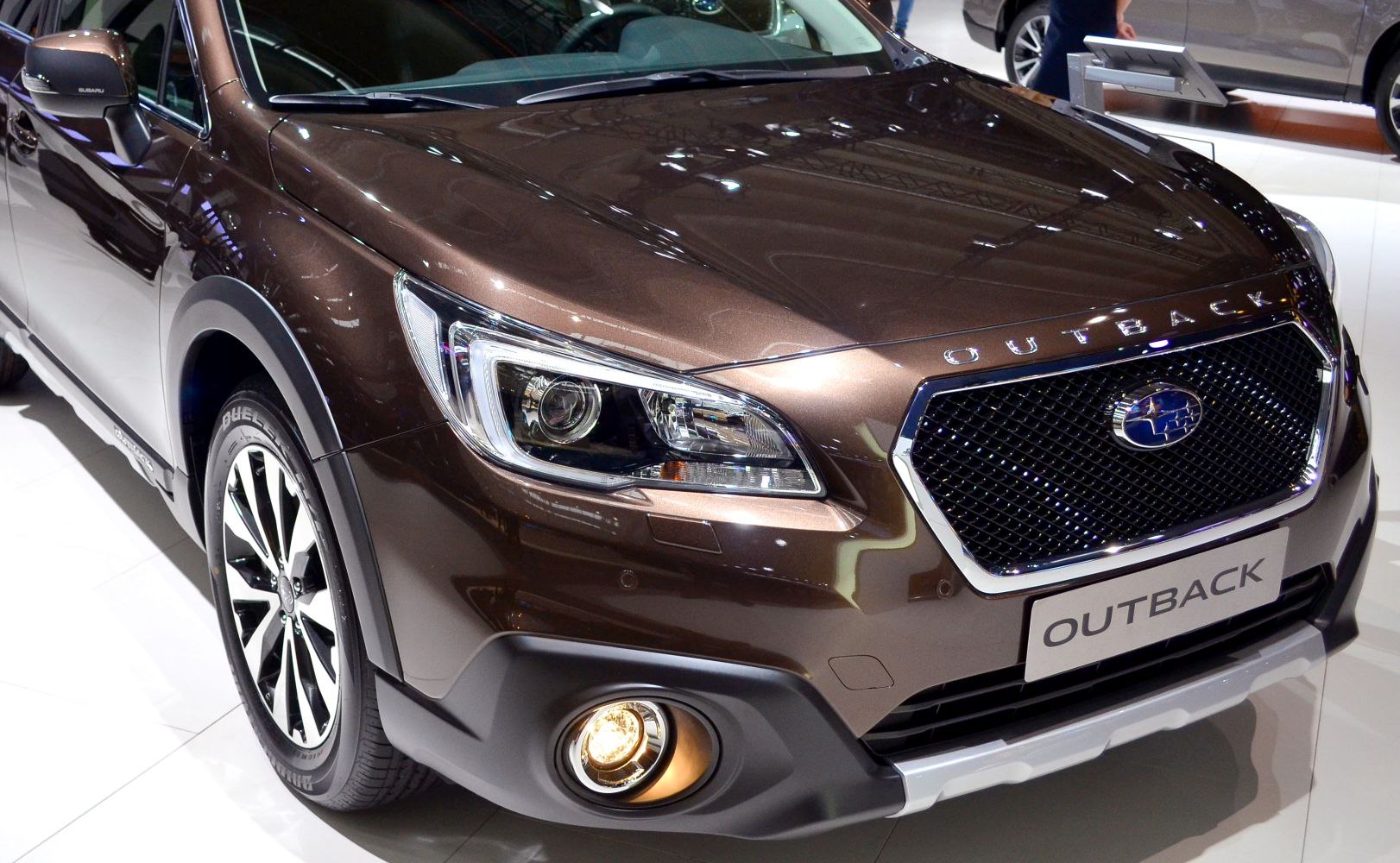 Close-up of front headlight, grille, and fog light