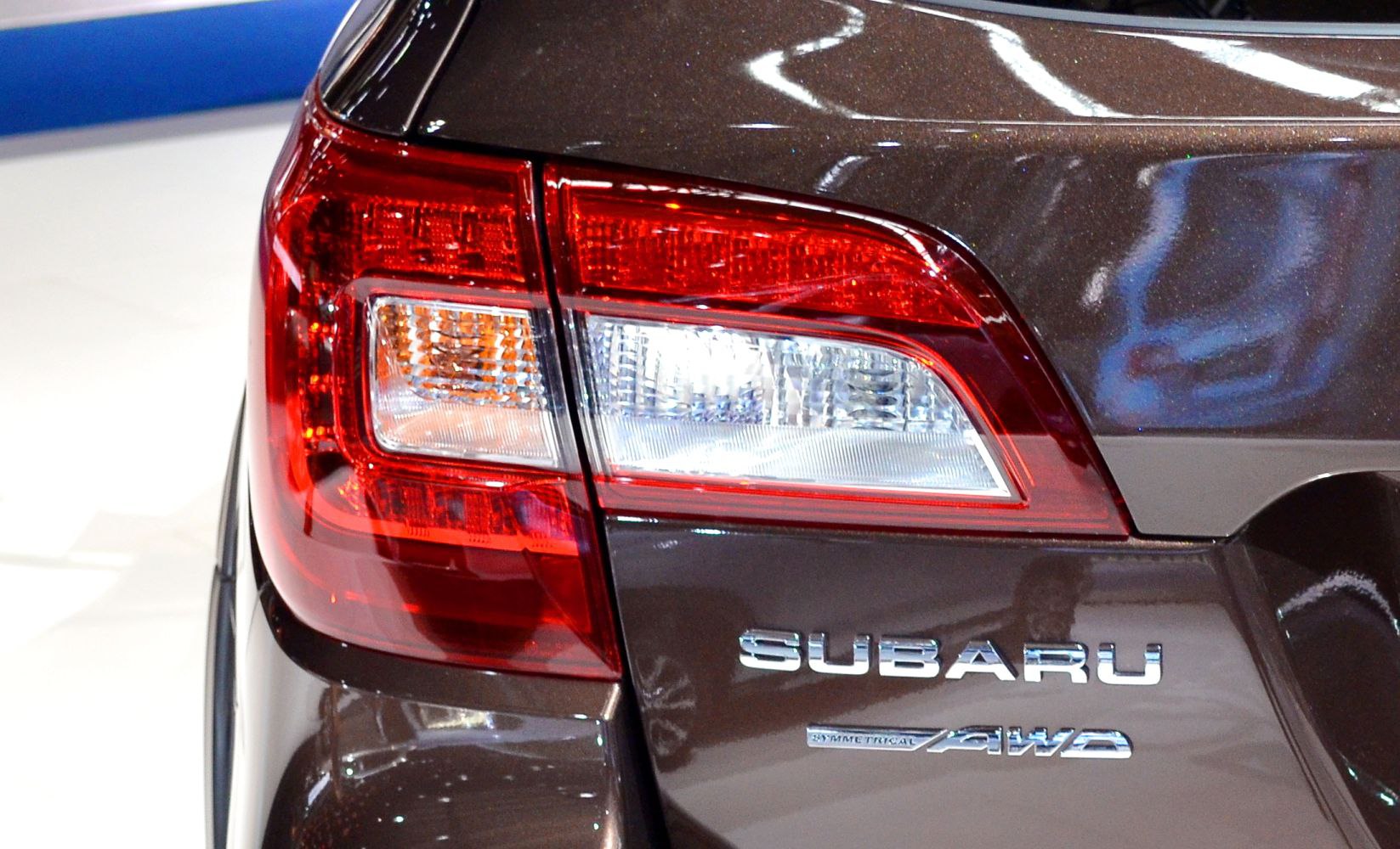 Tail light and AWD badge on dark brown rear quarter panel