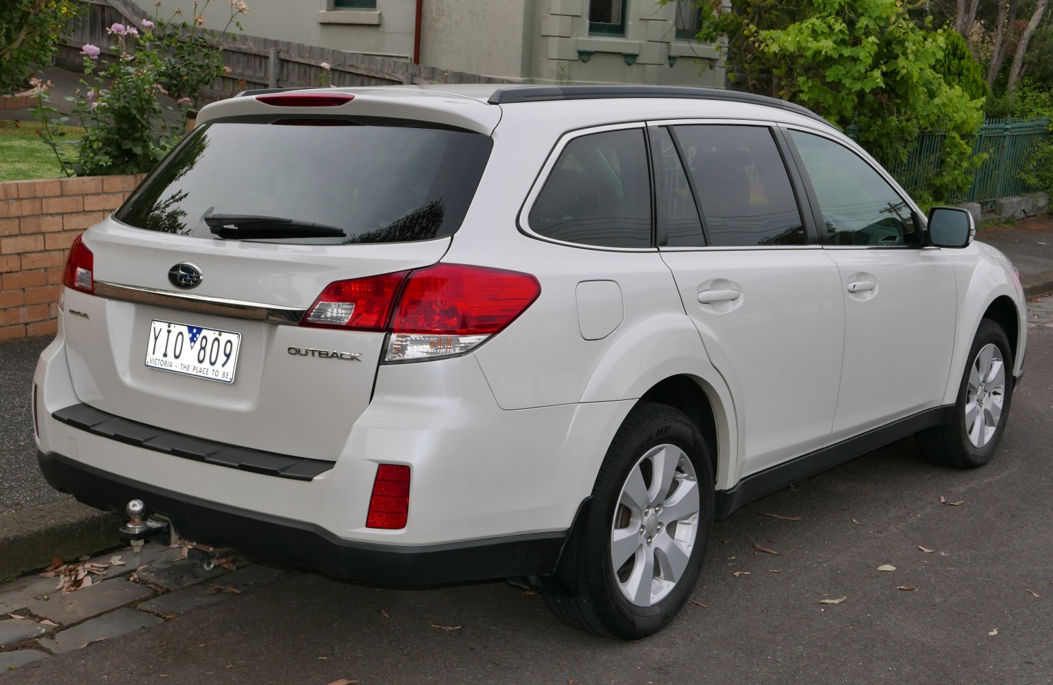 Rear side view of station wagon with taillights and roof rails