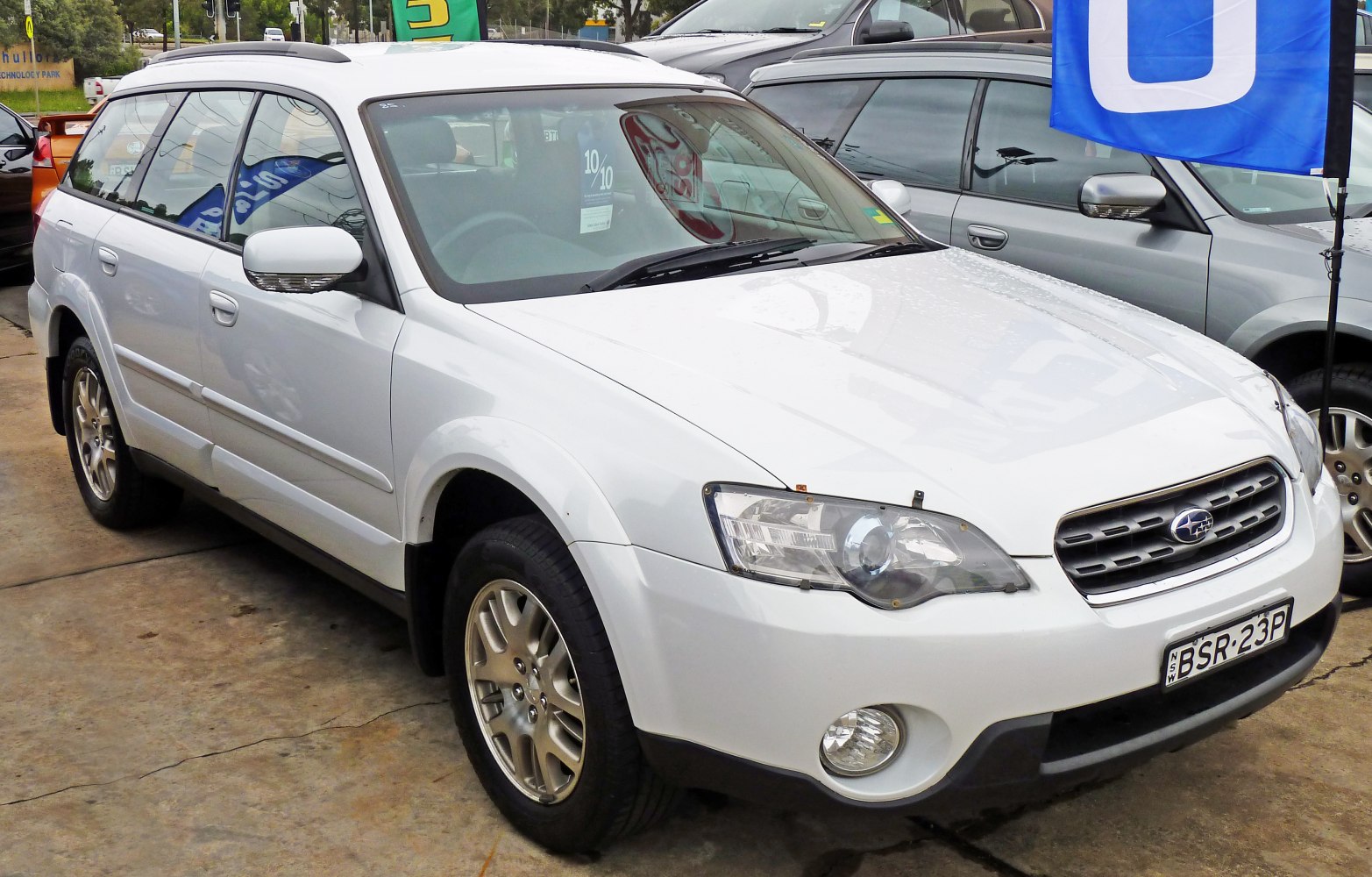 White station wagon front side view with roof rails and alloy wheels