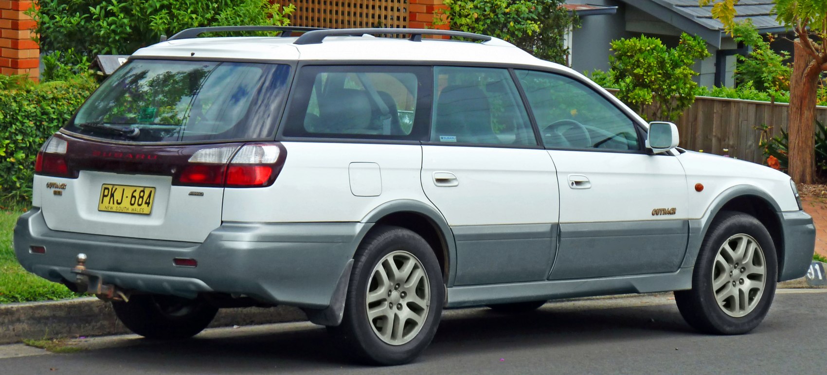 Rear side view of a classic station wagon with roof rails and rugged lower body cladding