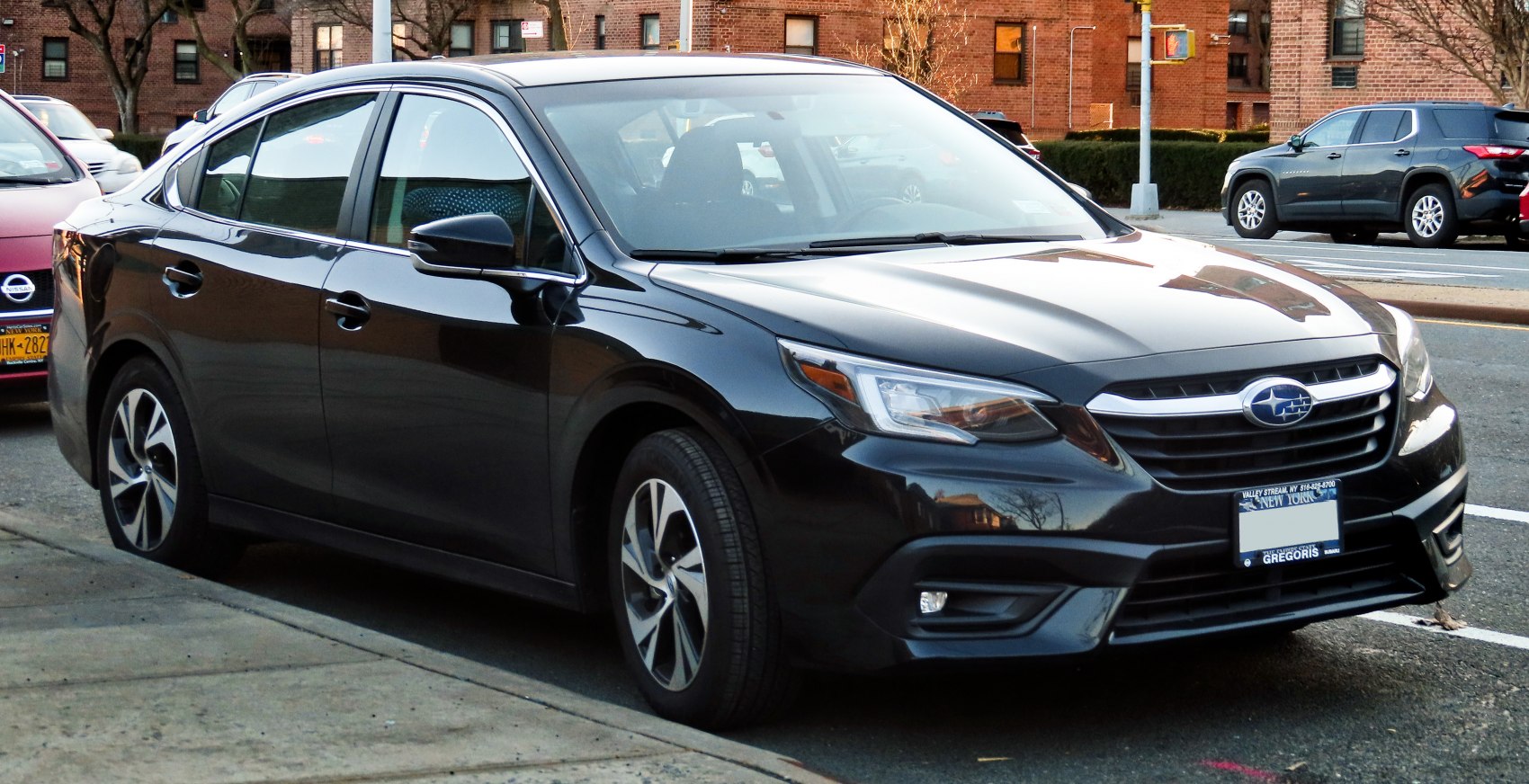 Front side view of a sedan with sleek headlights and alloy wheels