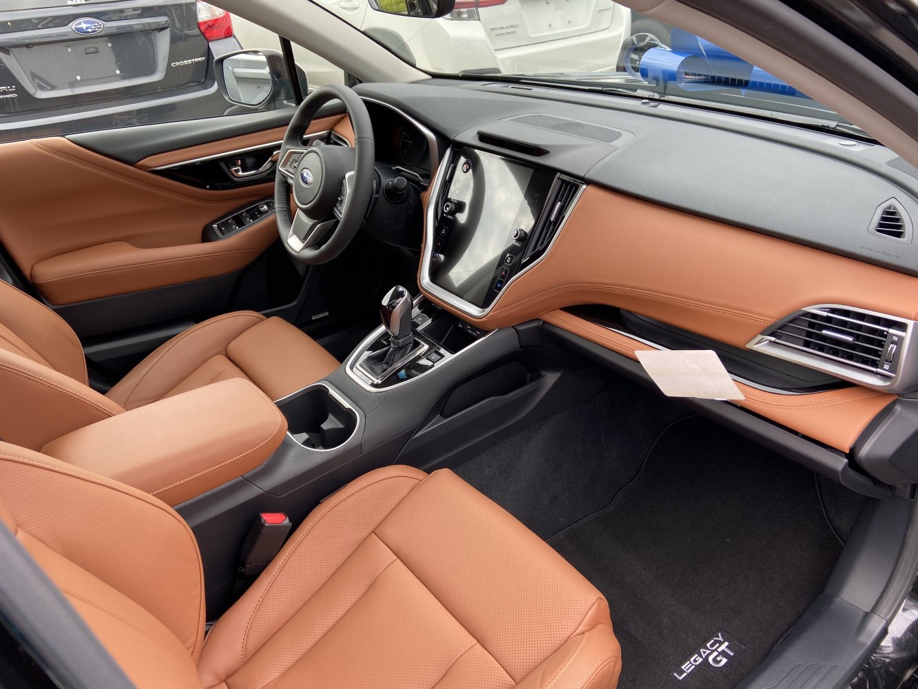 Tan leather seats and large touchscreen infotainment system interior
