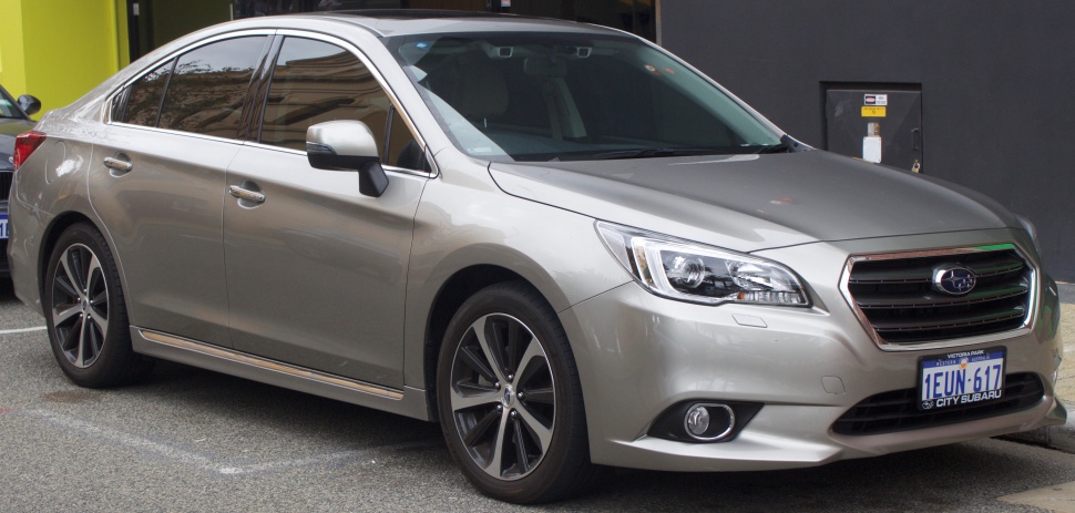 Front side view with alloy wheels and distinctive grille.