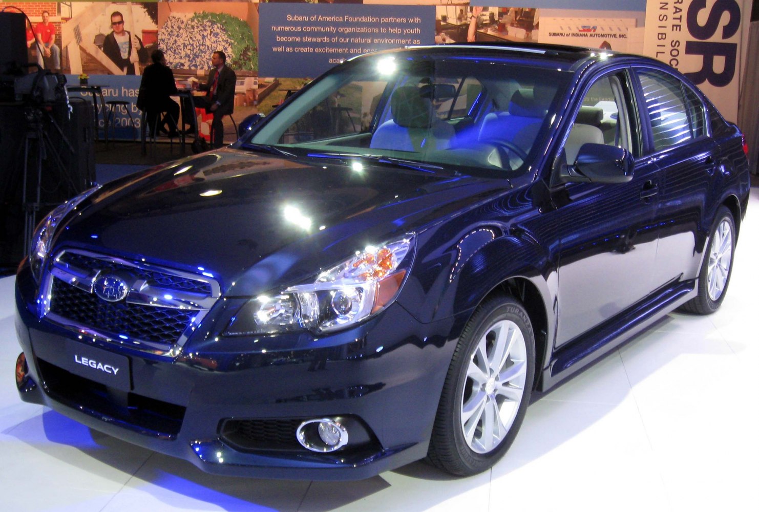 Front and side view of a 2012 sedan with grille, headlights, and alloy wheels
