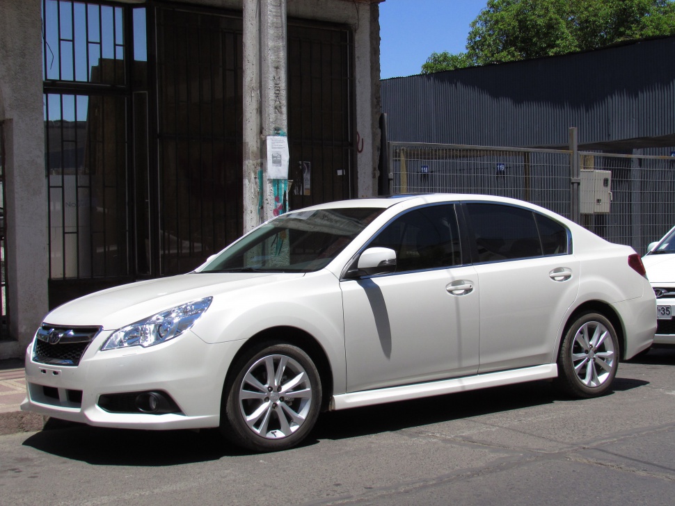 White mid-size sedan with alloy wheels, tinted windows, and facelift front design
