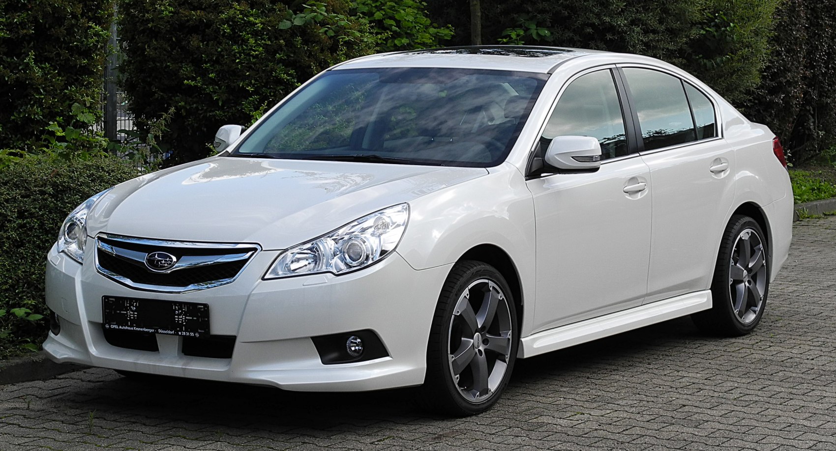 Front-side view of sedan with alloy wheels and fog lights