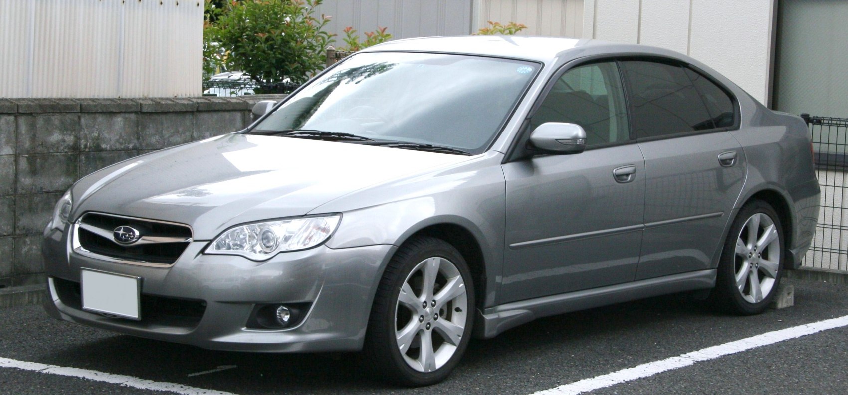 Silver sedan with clear headlights and alloy wheels