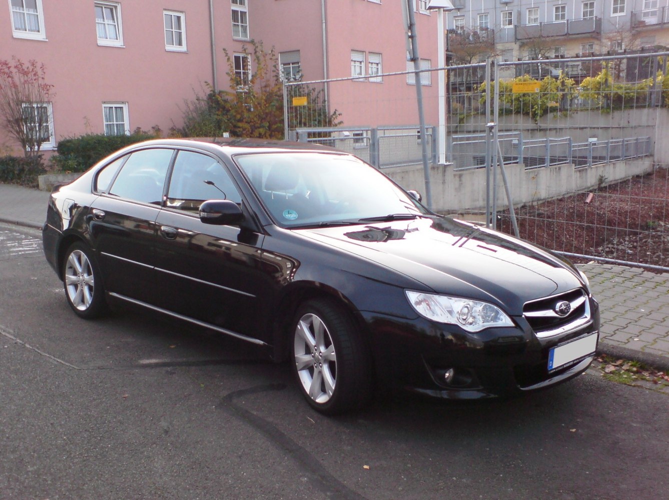 Black sedan with sleek front and side profile, alloy wheels