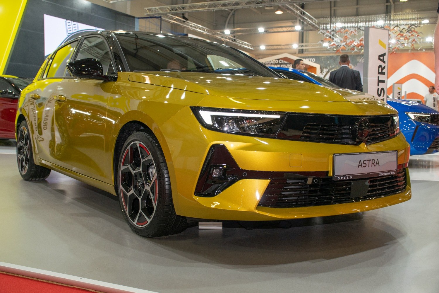 Yellow hatchback with sharp LED headlights and sporty wheels