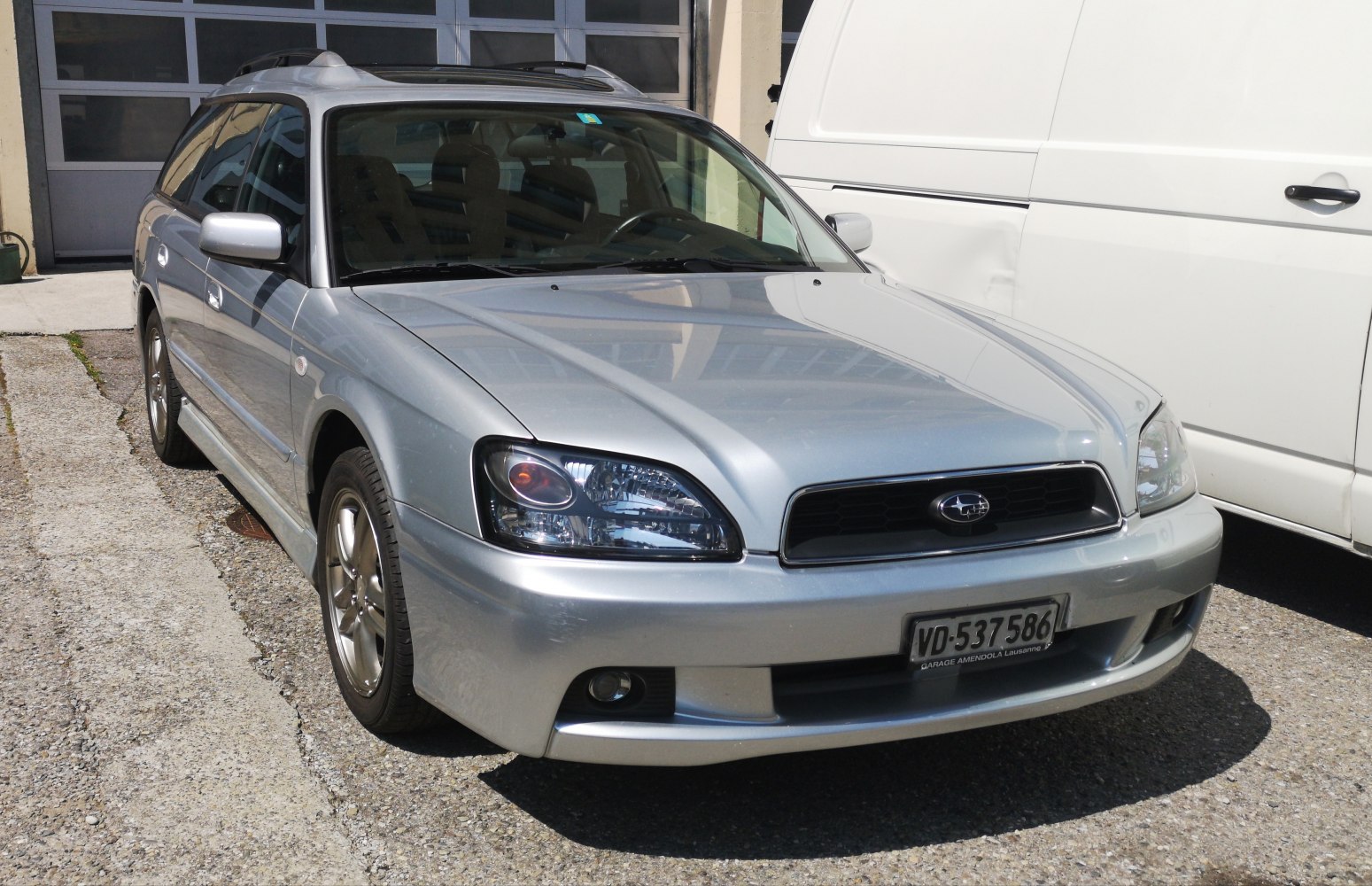 Front view of station wagon with headlights, fog lights, and roof rails