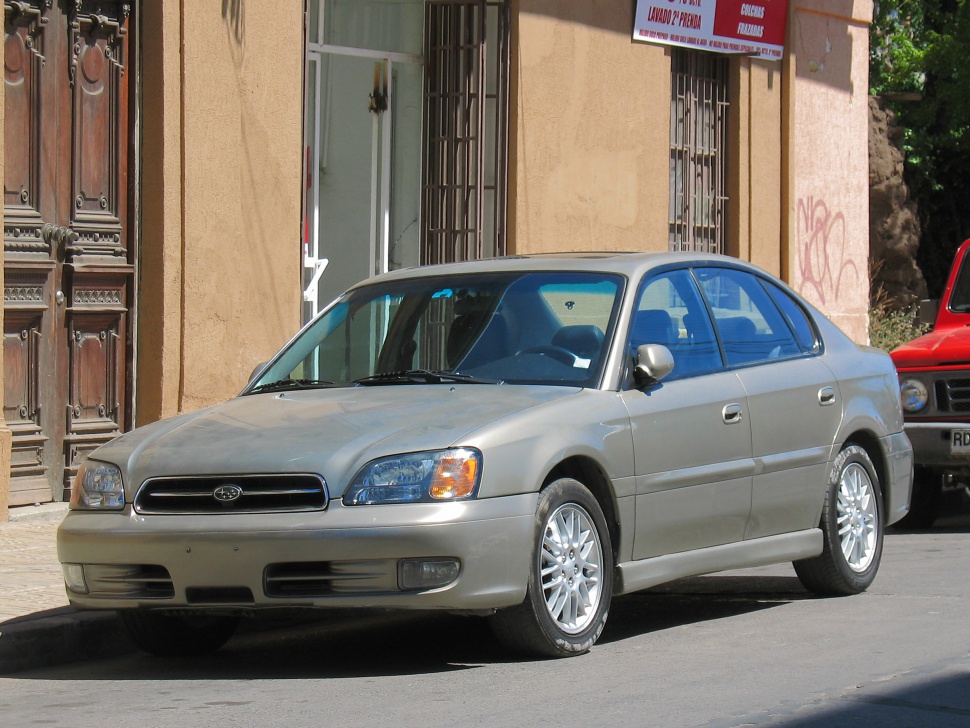 Silver sedan front and side view with alloy wheels and four doors