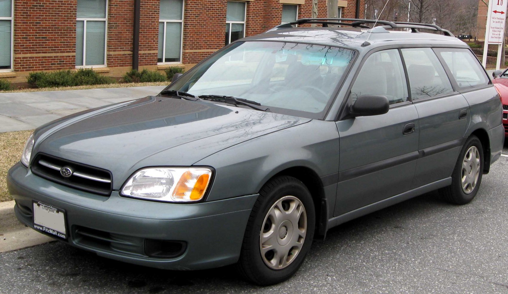 Front three-quarter view of station wagon with distinctive headlight and roof rack