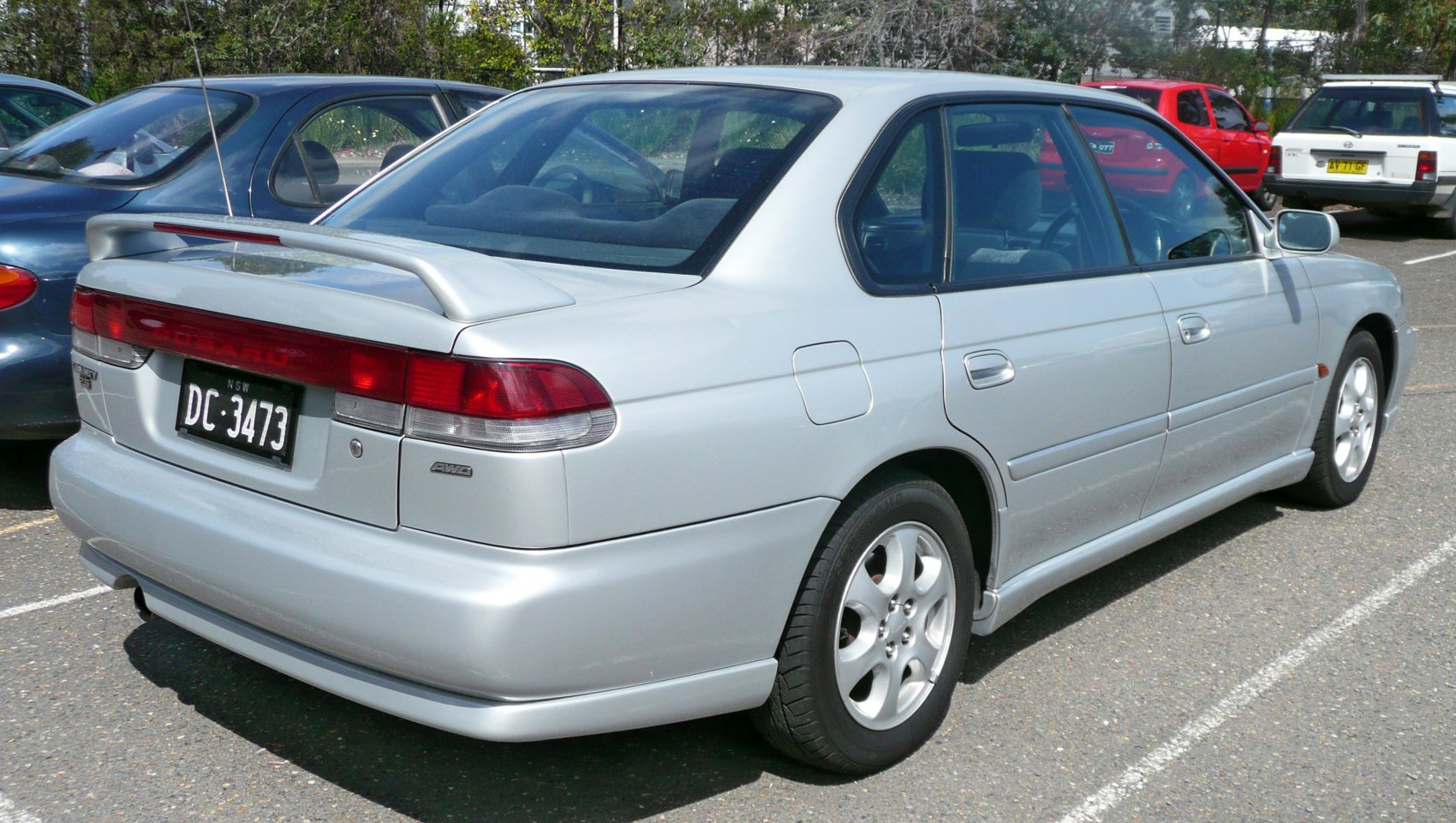 Silver sedan with rear spoiler and alloy wheels