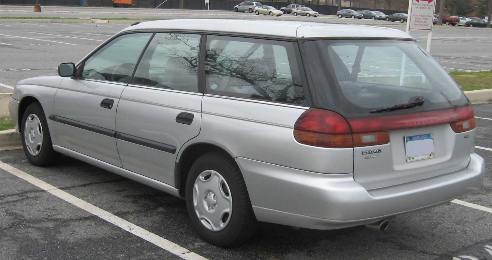 Rear side view of a silver station wagon with distinctive tail lights and smooth body design.