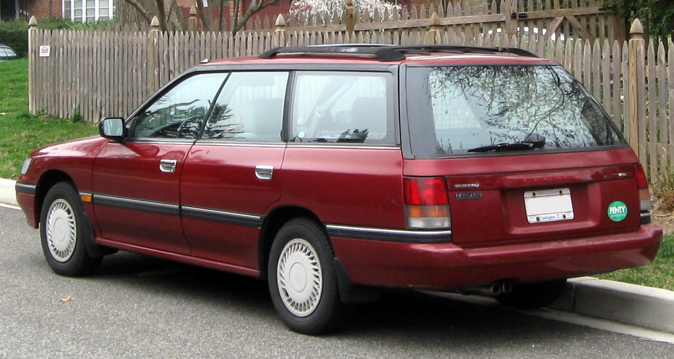 Rear side view of a classic station wagon with roof rack