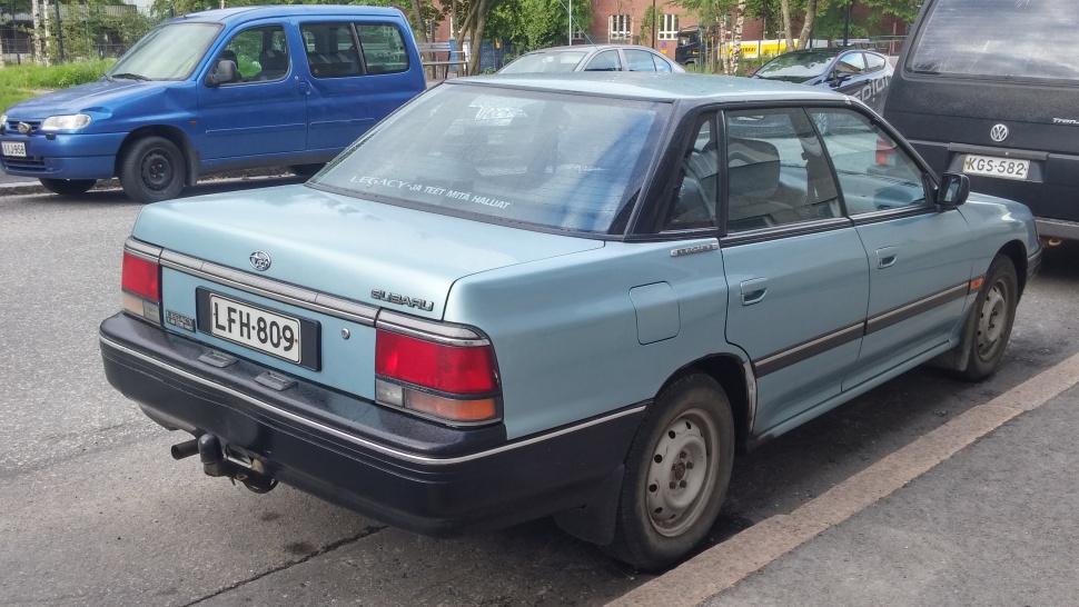 Rear side of vintage sedan with tow hitch and classic taillights