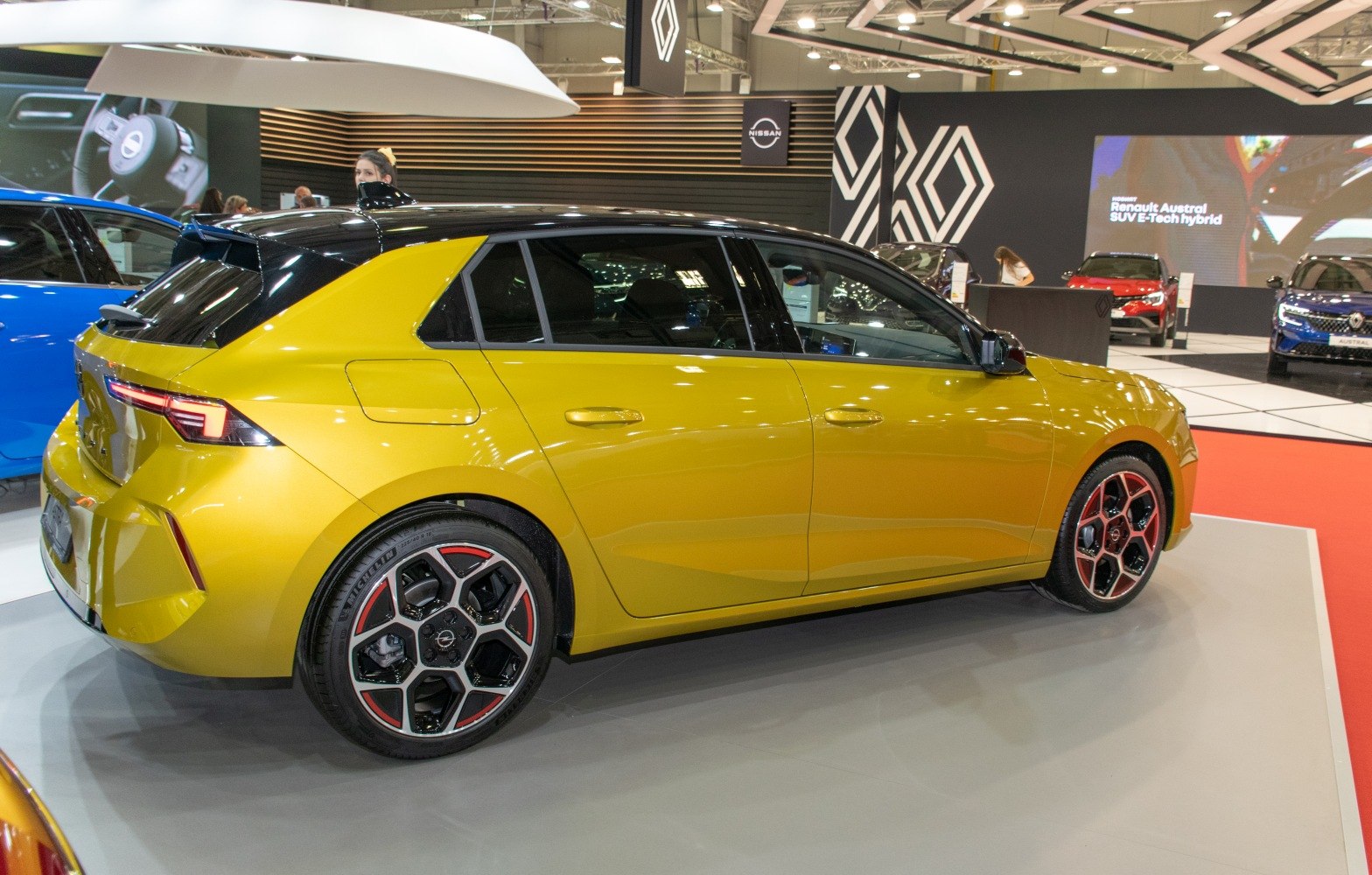 Side profile of a hatchback with two-tone paint and distinctive alloy wheels