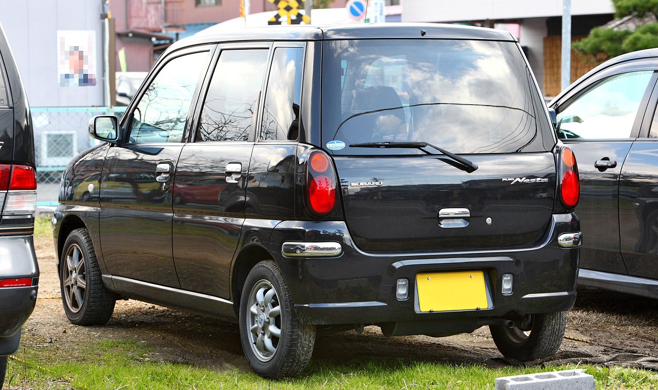 Rear side view with tinted windows and round vertical taillights