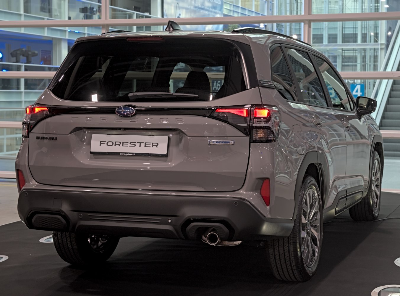 Rear view of SUV with illuminated LED tail lights and e-Boxer badge.
