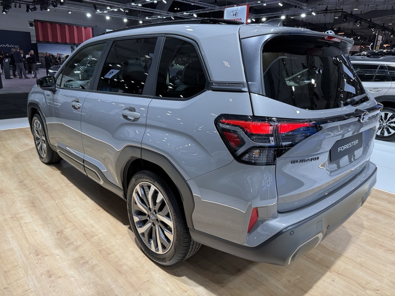 Rear and side profile view with tail lights and alloy wheels