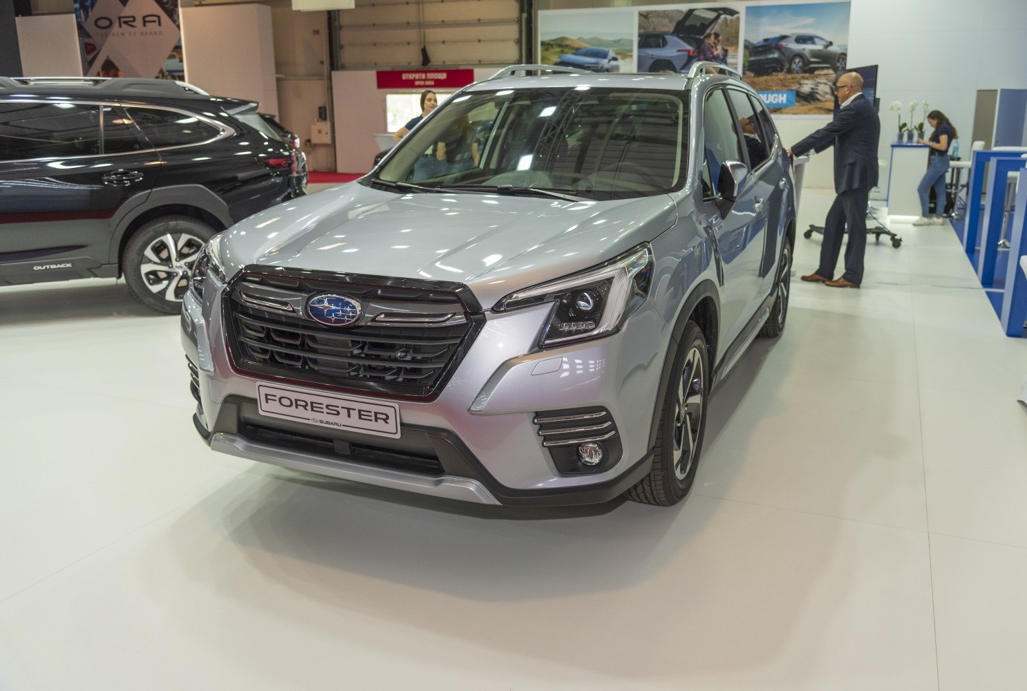 Silver modern SUV front view with LED headlights and bold grille