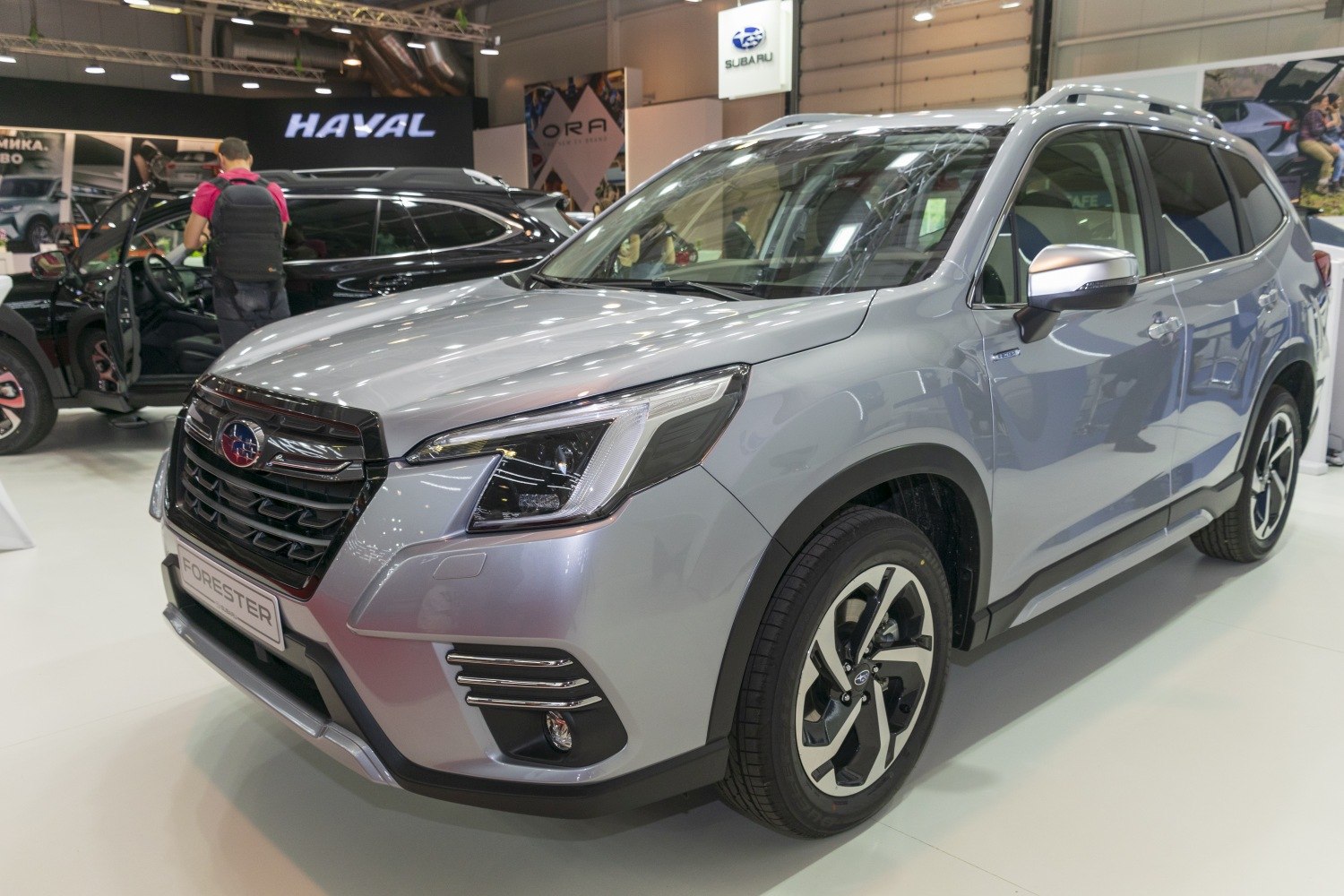 Front-side view of a silver SUV highlighting headlights and alloy wheels