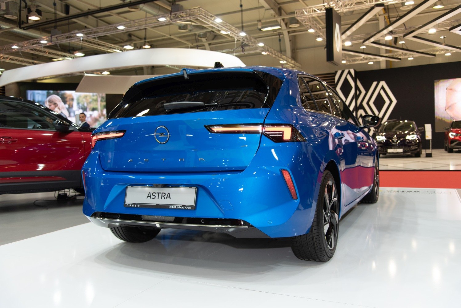 Rear view of a modern blue hatchback with sleek taillights and sporty details.