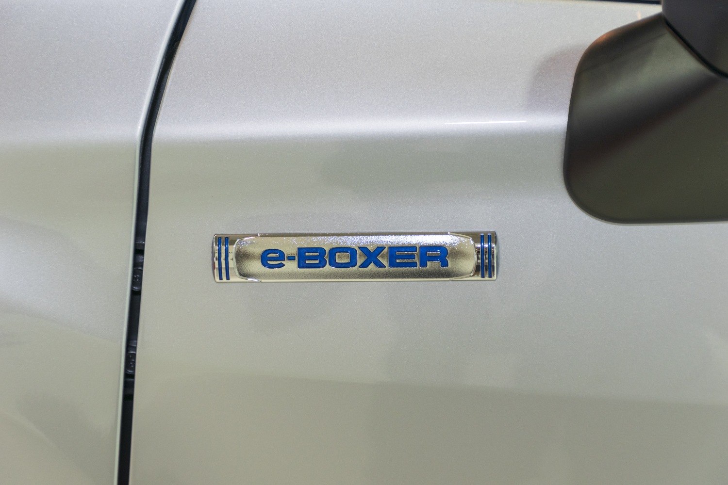 Close-up of e-BOXER hybrid badge on car door near mirror