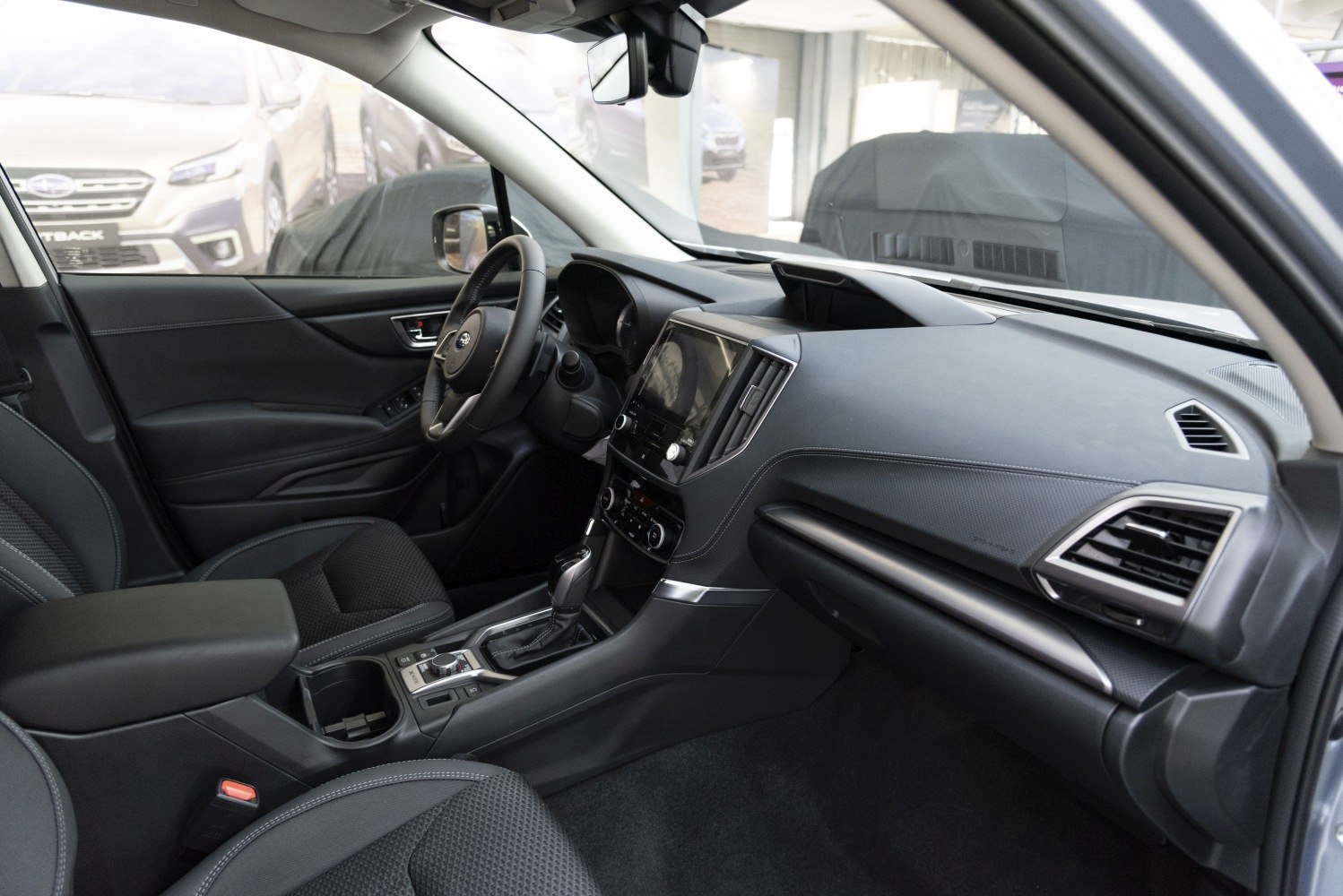 Modern car interior with dashboard, steering wheel, and center console