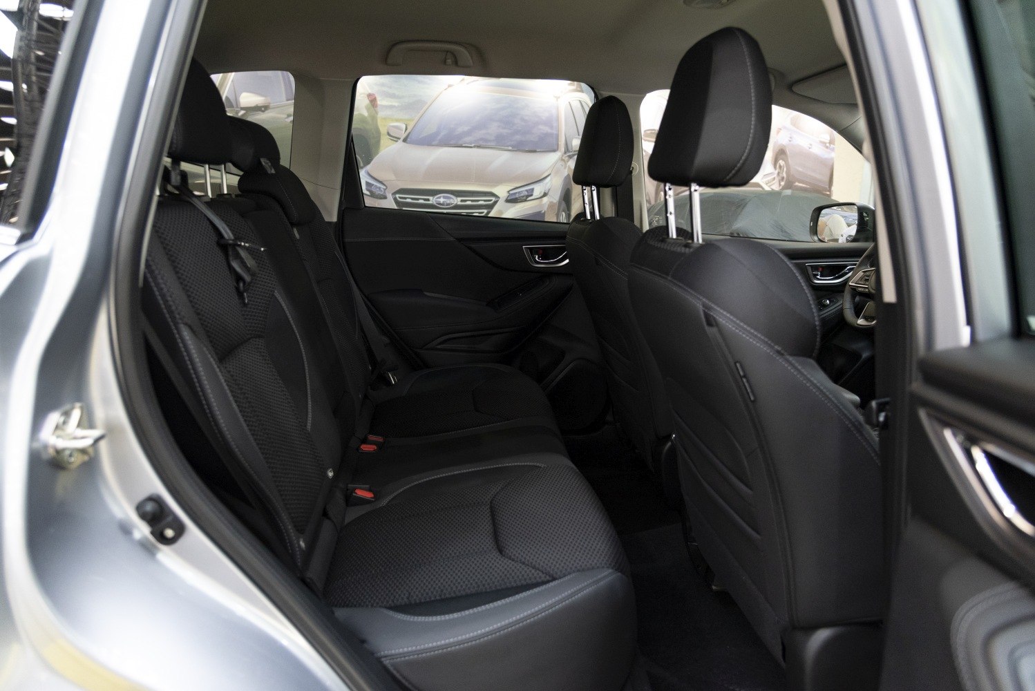 Spacious rear seat interior with black perforated upholstery and ergonomic design