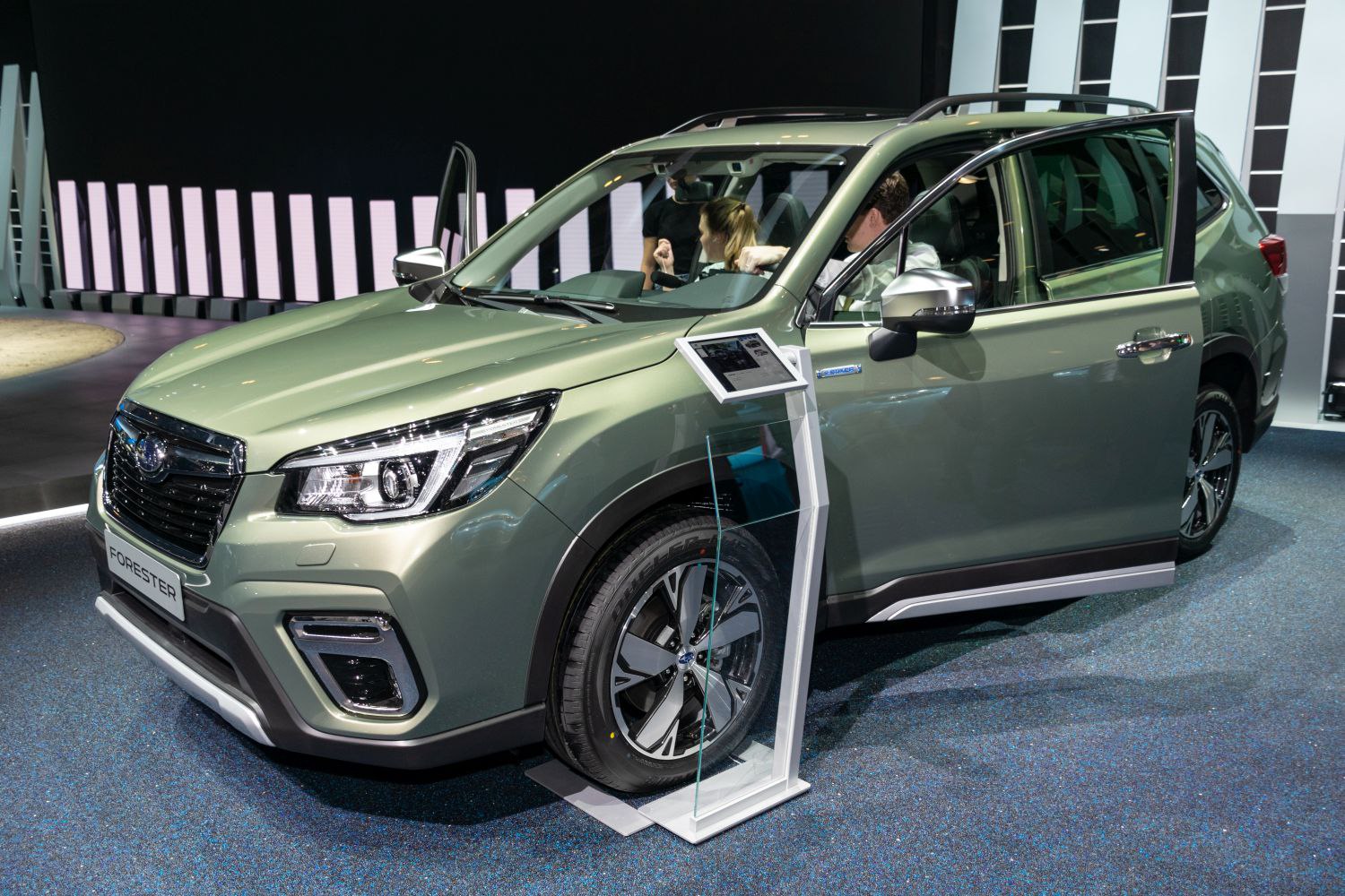 Subaru SUV front with open doors and display panel