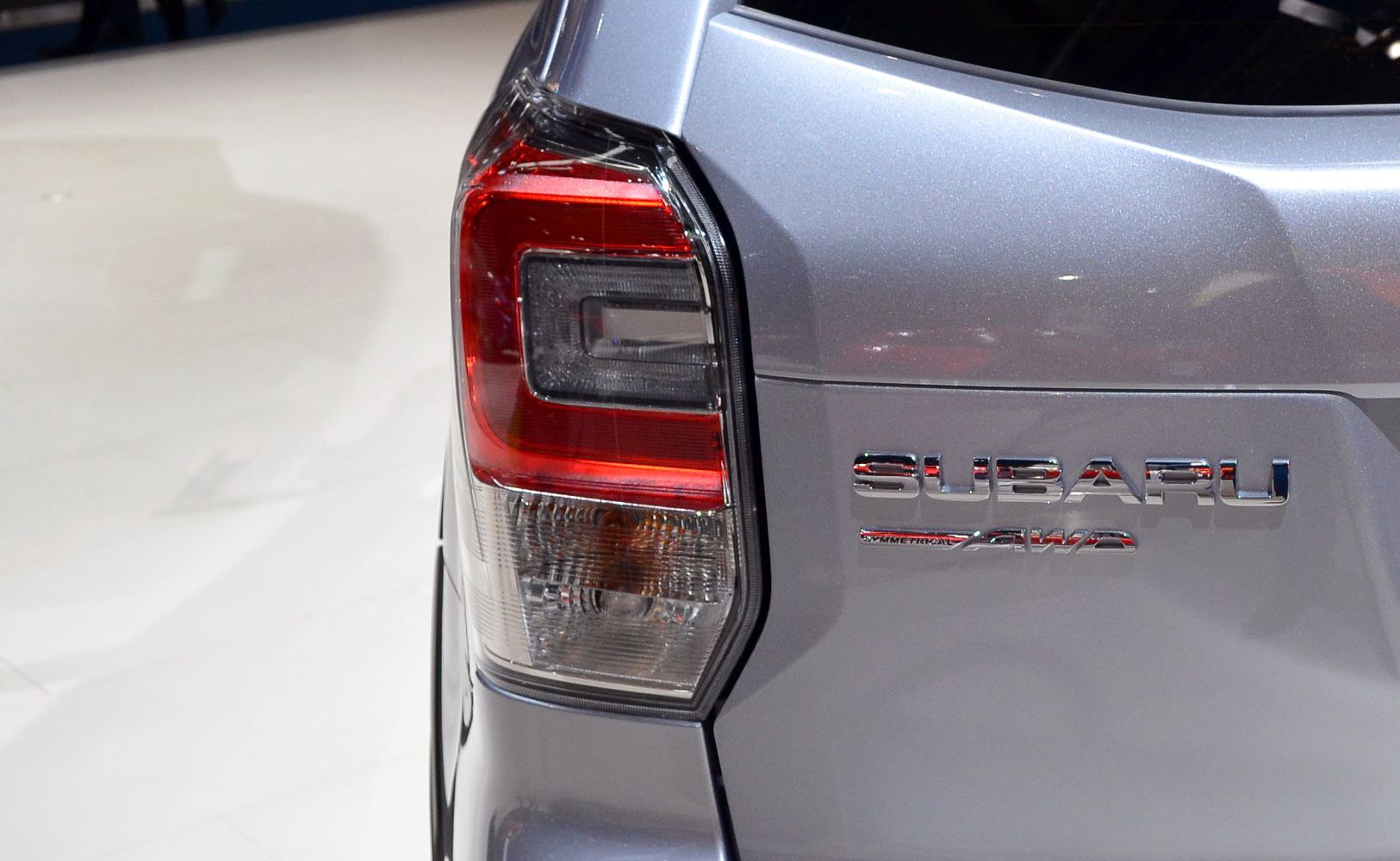 Close-up of rear tail light and AWD badge on silver SUV