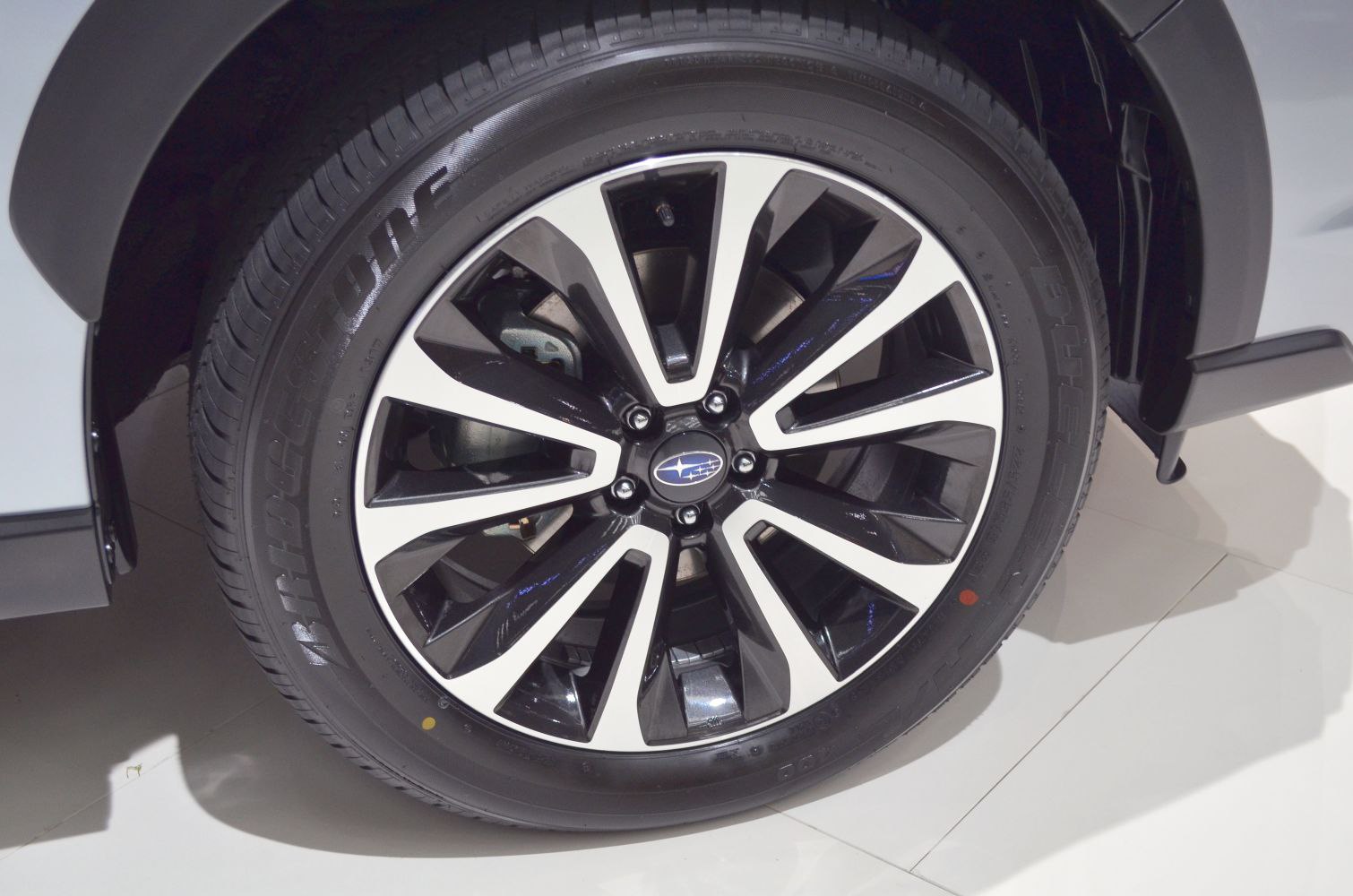 Multi-spoke alloy wheel with Bridgestone tire tread