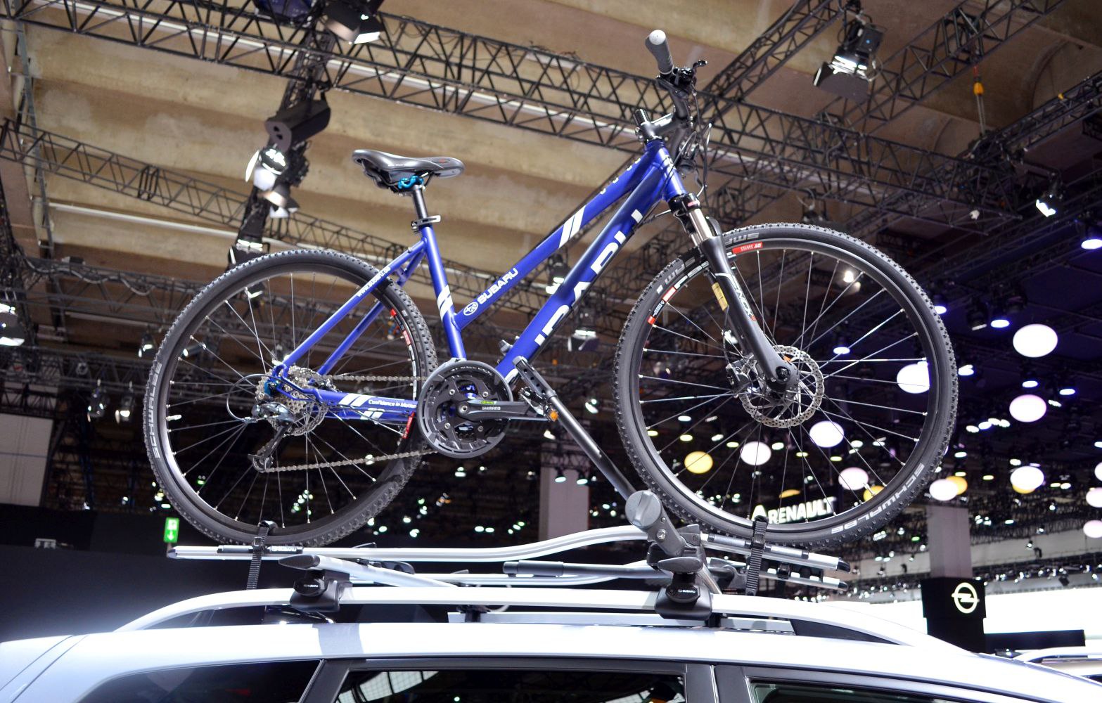 Blue mountain bike mounted on vehicle roof bike rack