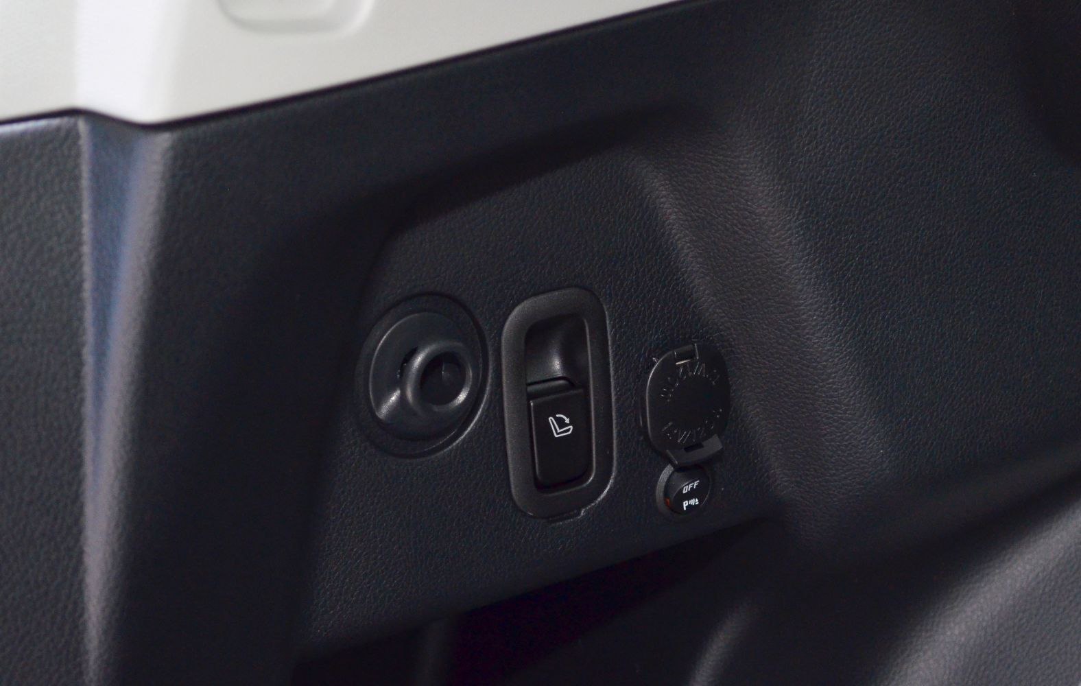 Rear seat control switch and 12V power outlet in vehicle interior