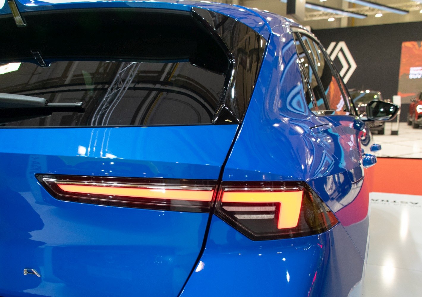 Close-up of a sleek LED tail light on a blue modern hatchback rear end