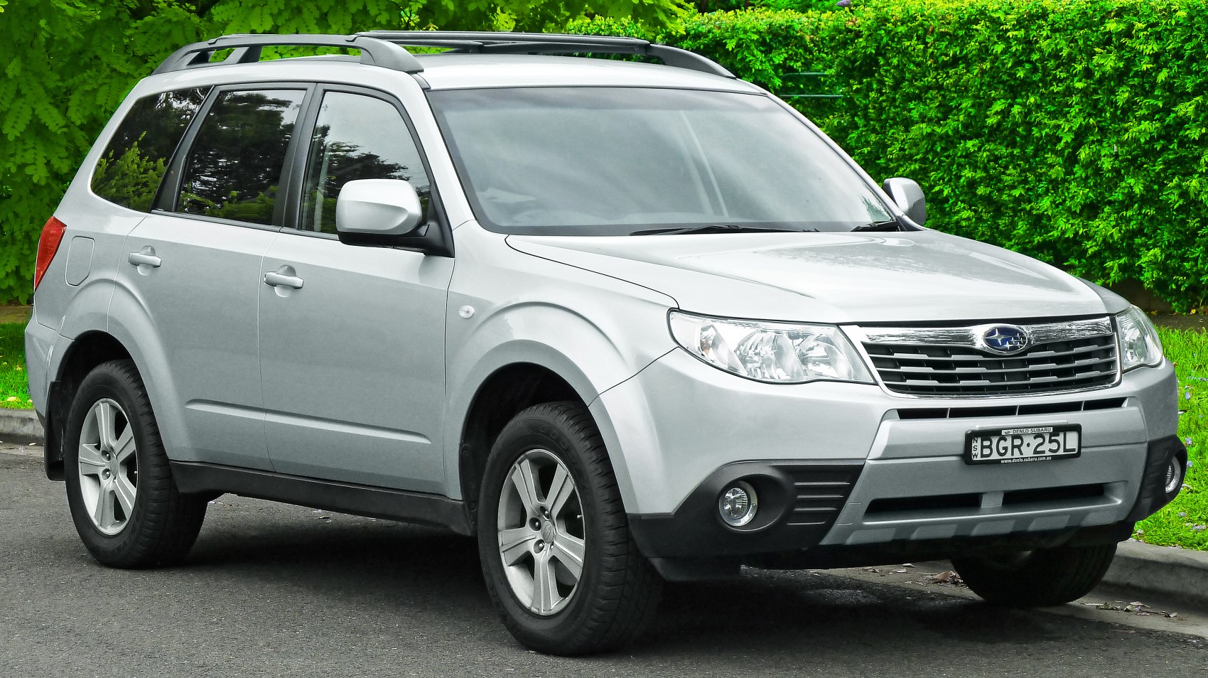 Silver SUV with roof rails, alloy wheels, and fog lights