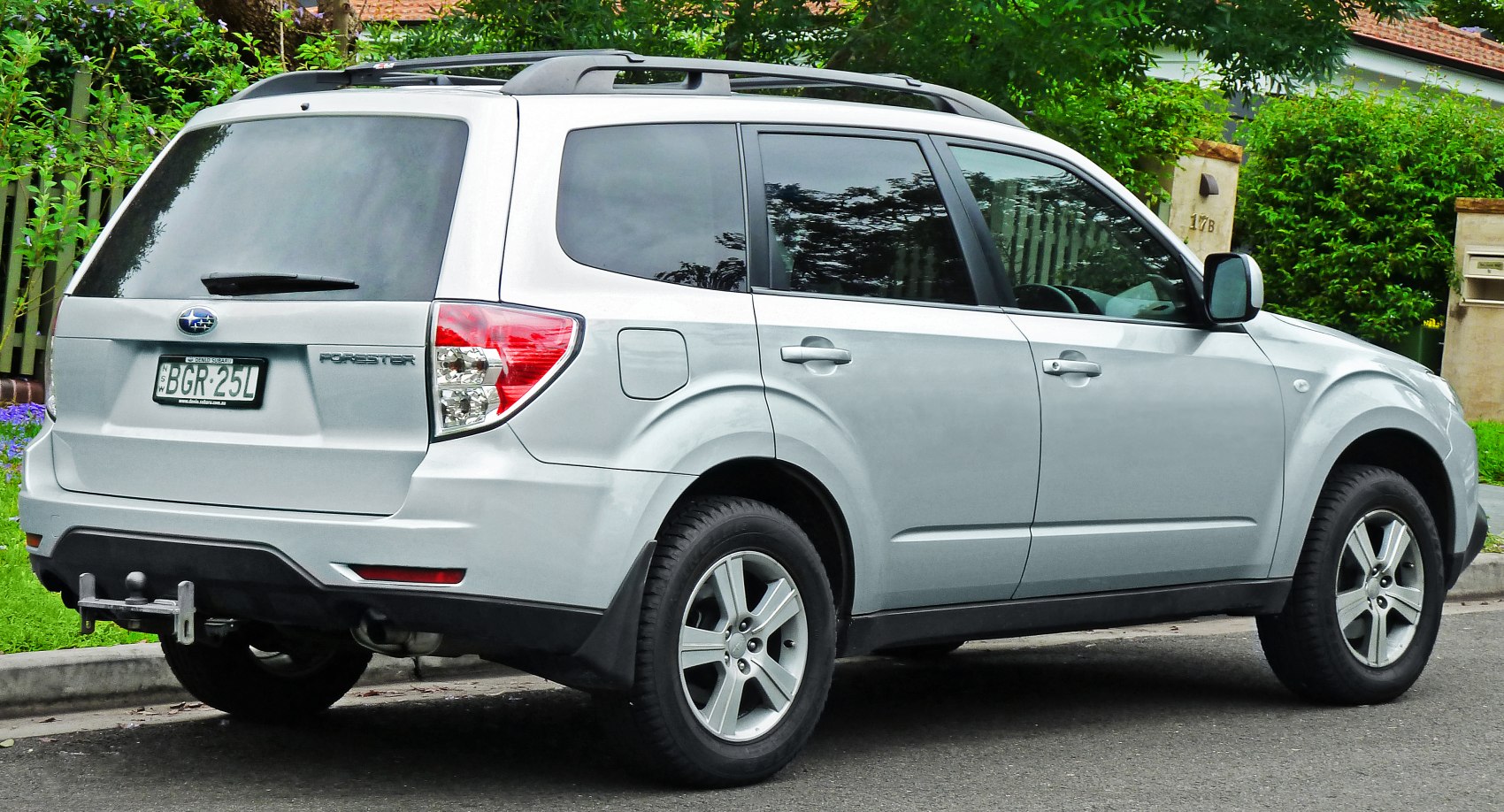 Compact SUV with roof rails, alloy wheels, rear tow hitch.