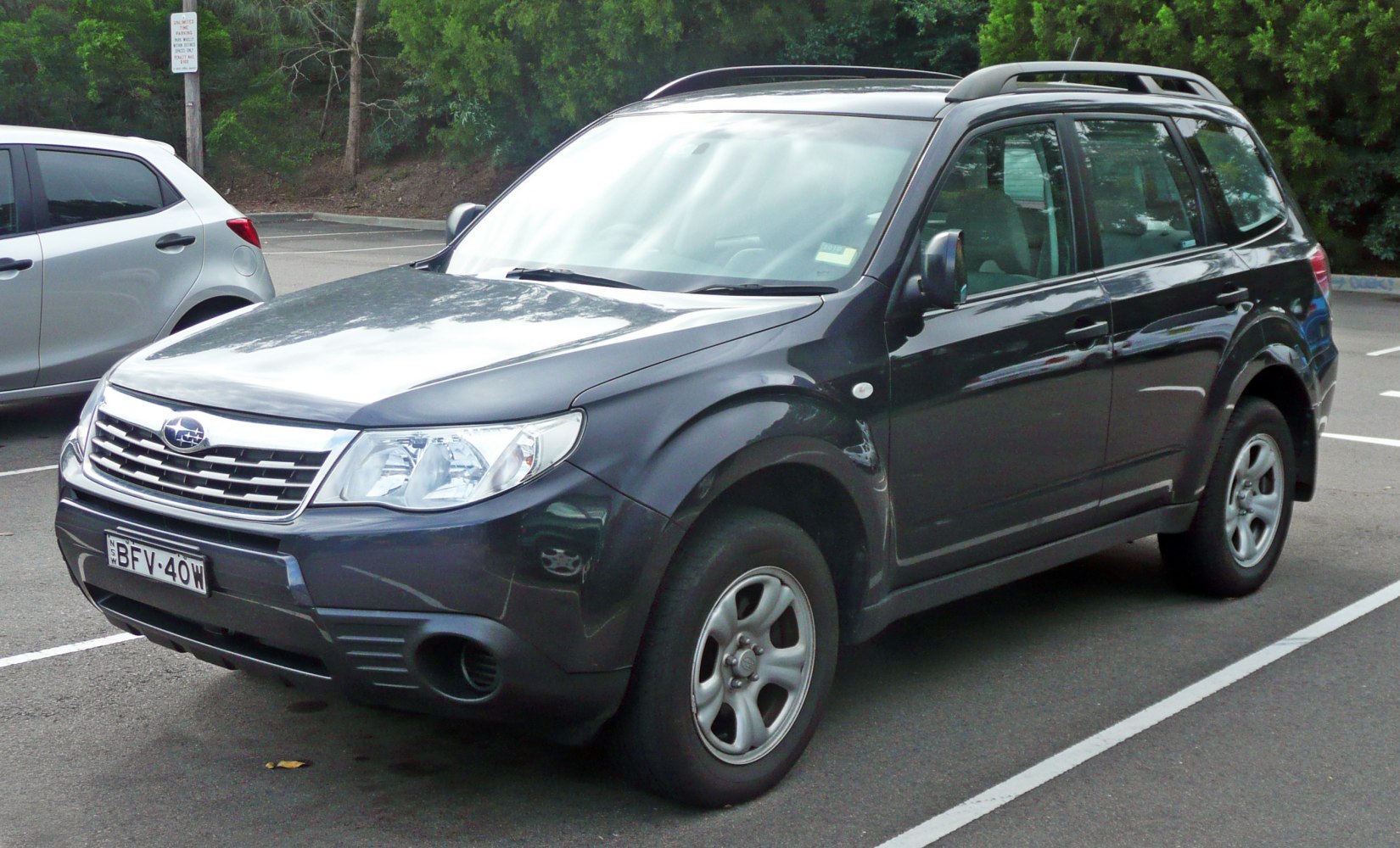 SUV with roof rails and front grille, parked outdoors