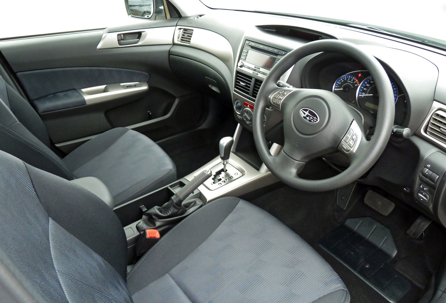 Dashboard, steering wheel, seats, and center console of a car interior