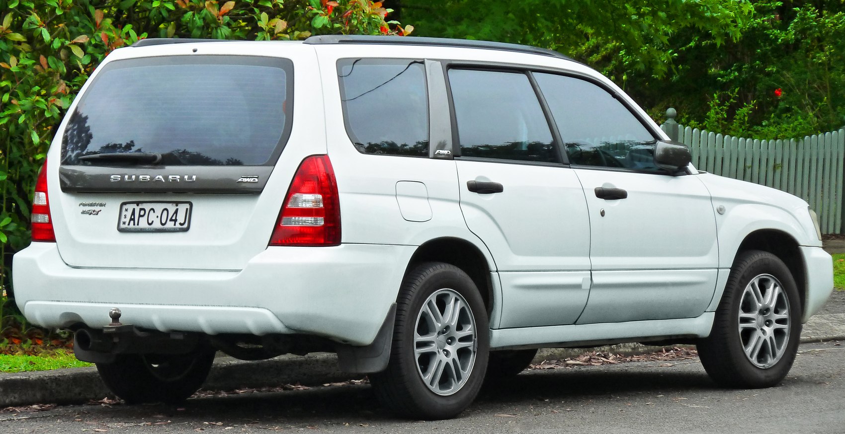 Rear and side profile of a white SUV with AWD and alloy wheels