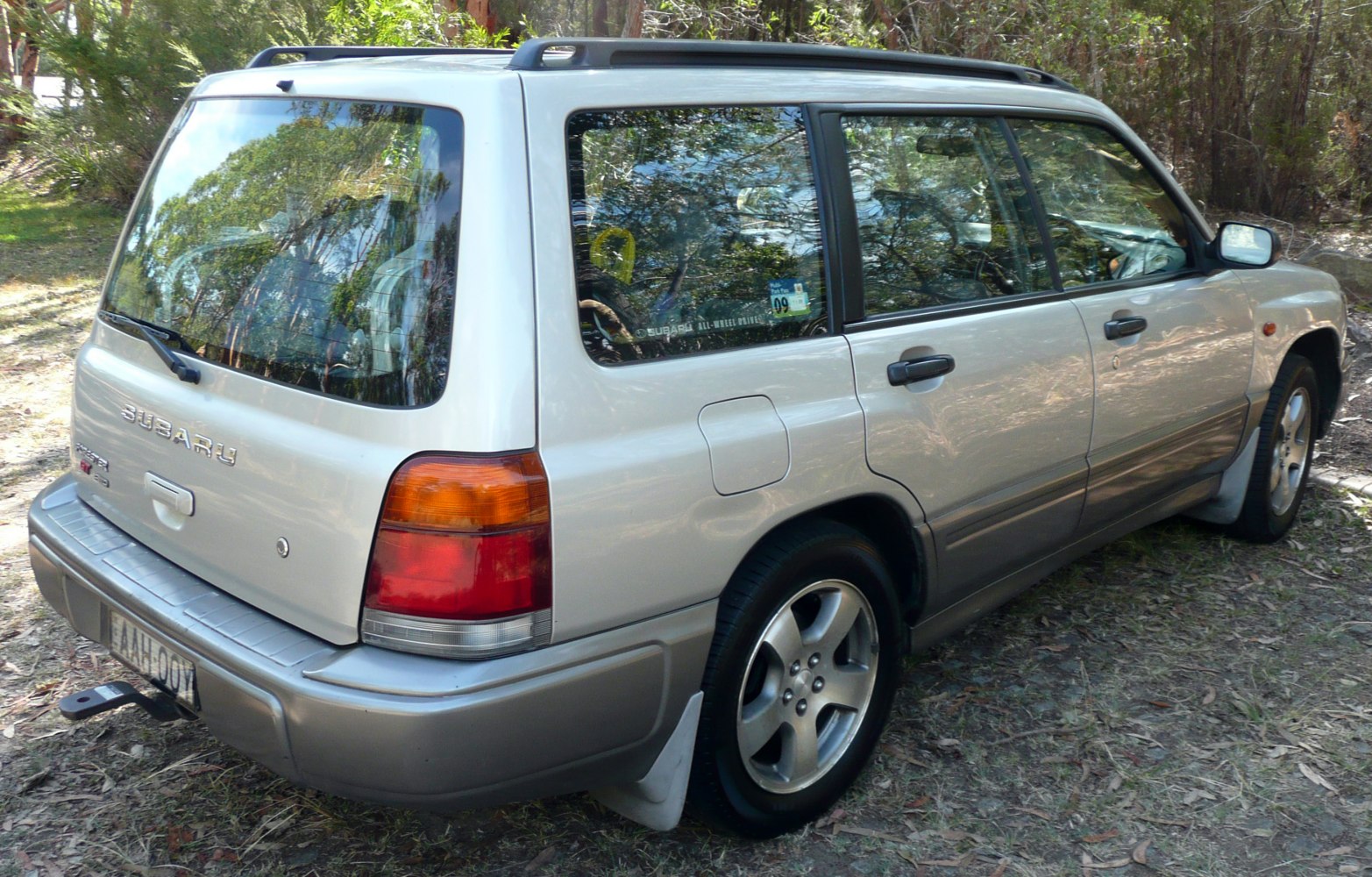 Rear side view of SUV with alloy wheels and roof rails