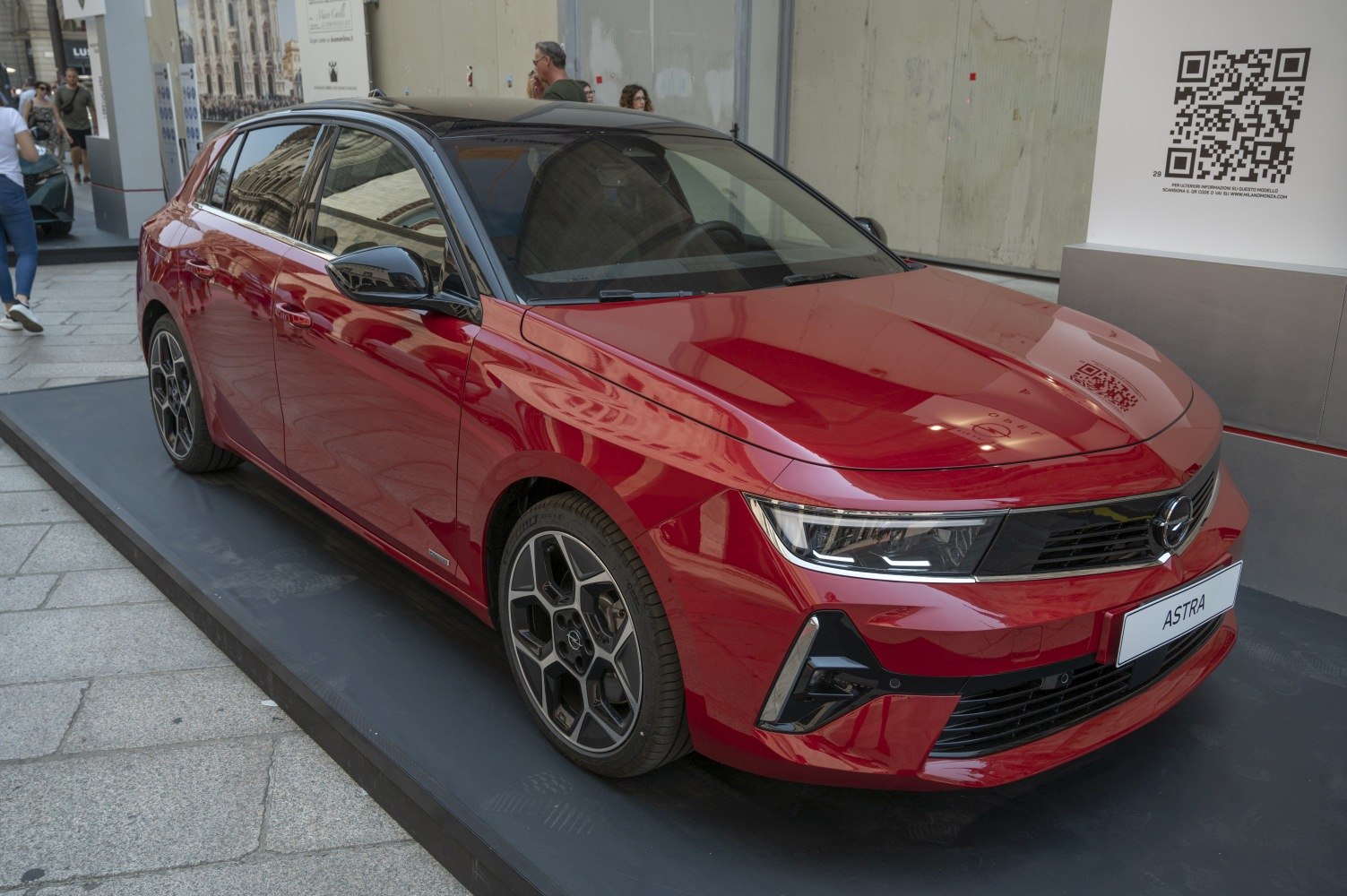 Red hatchback with modern LED headlights and sporty alloy wheels