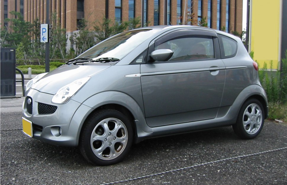 Silver compact hatchback with rounded headlights and five-spoke alloy wheels