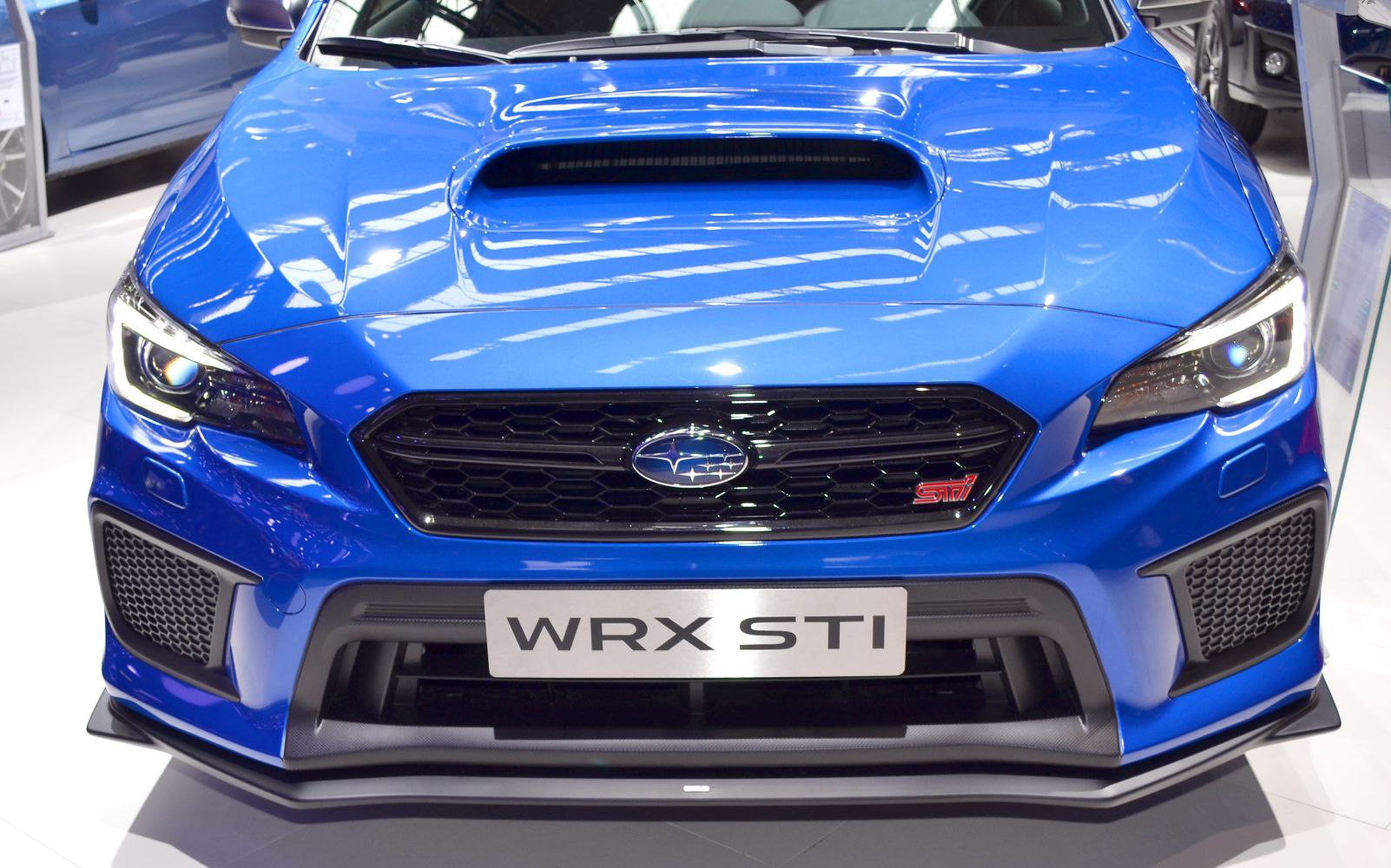 Front view with prominent hood scoop and aggressive grille