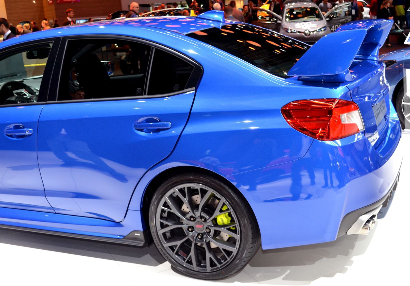 Blue sedan rear with sporty spoiler and alloy wheels