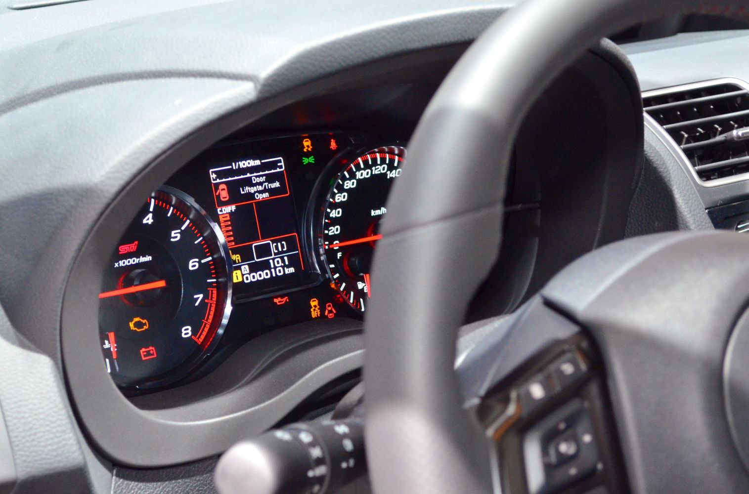 Digital instrument cluster with tachometer and speedometer display in car dashboard