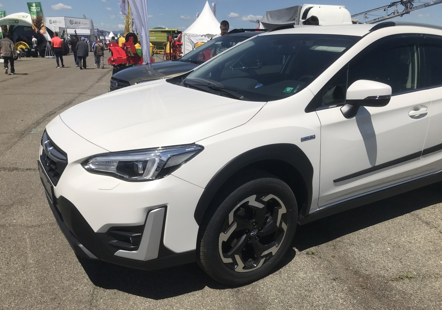 White compact crossover front side, angular headlights, alloy wheels.